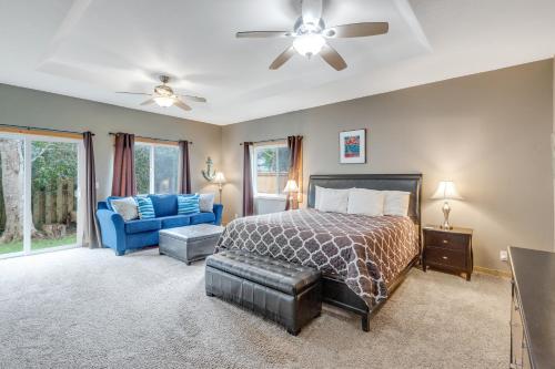 a bedroom with a bed and a blue couch at Once Upon a Tide in Lincoln City