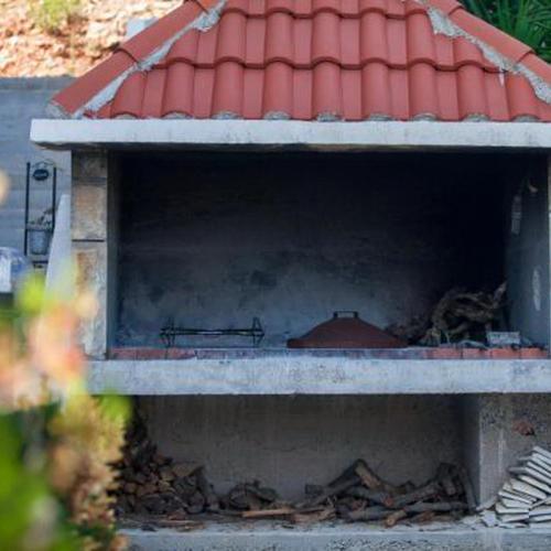 a cat sitting inside of a building at Apartments Bruna in Lastovo
