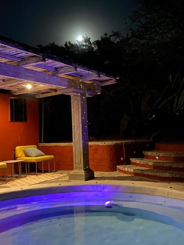 a swimming pool at night with a pergola at View Hotel Boutique in San Miguel de Allende