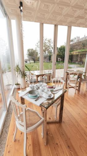 a dining room with a wooden table and chairs at Quinta de Travassinhos- Douro Valley & Spa in Santa Marta de Penaguião