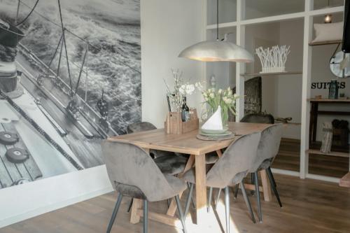 a dining room with a wooden table and chairs at N°1 Loft Am Yachthafen in Bad Zwischenahn