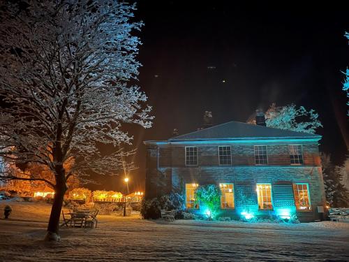a house with christmas lights on it at night at Oakhill Hotel in Matlock
