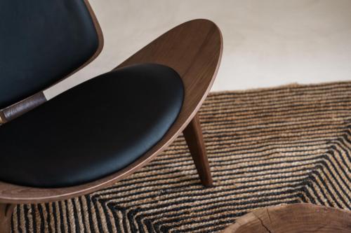 a wooden chair sitting on top of a rug at Leon Luxury Suites in Imerovigli