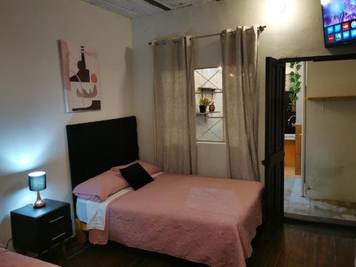 a small bedroom with a bed and a window at Hermoso departamento en el centro ciudad, casa M MELGAR in Arequipa