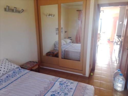 a bedroom with a bed and a large mirror at Casa Anita in Costa de Antigua