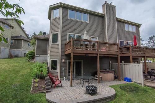 a house with a deck and a patio at Marsh Run Cove in McHenry