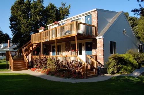 a house with a deck on the side of it at Breezeway Boutique Hotel in Westerly