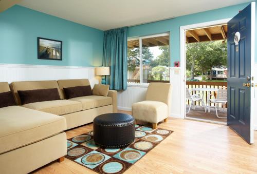 a living room with a couch and a chair at Breezeway Boutique Hotel in Westerly