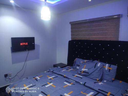 1 dormitorio con 1 cama con reloj en la pared en Parandiapartment, en Lagos
