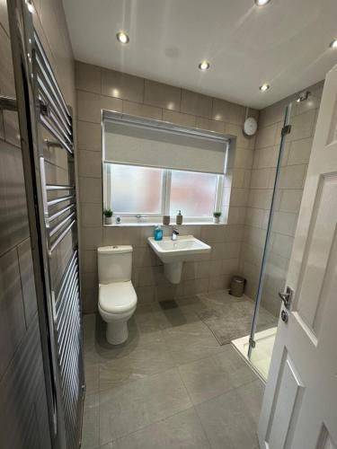 リバプールにあるWatford Road House Liverpoolのトイレ、洗面台、窓のあるバスルーム