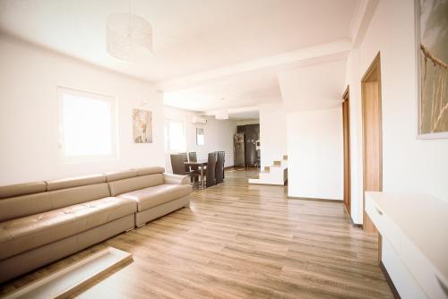 a living room with a couch and a dining room at Villa Katerina & Pool in Gevgelija