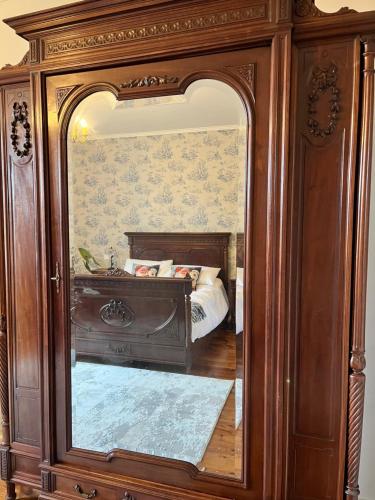 a reflection of a bed in a mirror at Chez Jallot in Vidaillat