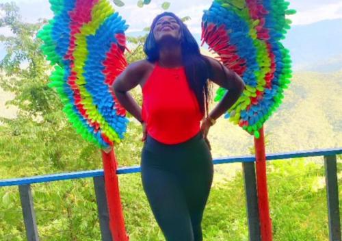 a woman is standing next to two large balloons at Chinauta_Eco_Glamping in Fusagasuga