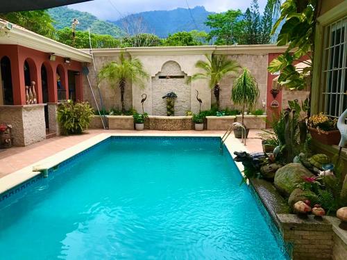 a swimming pool in the backyard of a house at Refugio de la Montaña B&B in San Pedro Sula