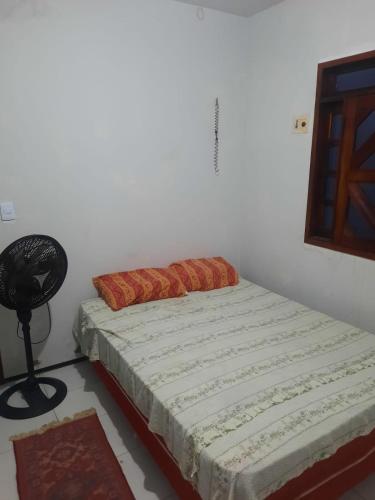 a bedroom with a bed and a fan in it at Casa com piscina in Juazeiro do Norte