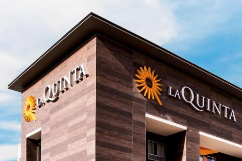 a building with sunflowers on the side of it at La Quinta Inn & Suites by Wyndham Sulphur Lake Charles in Sulphur