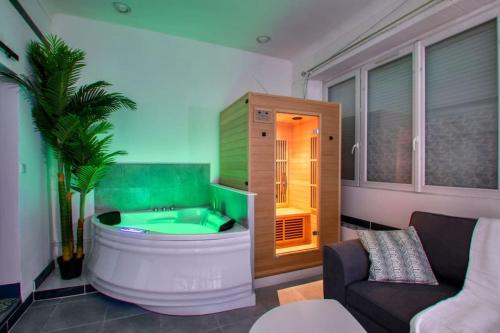 a bathroom with a large tub in a living room at Séjour Sauna et Jacuzzi Cocon Nantais. in Nantes