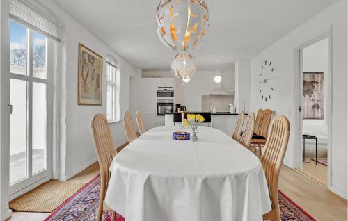 a white dining room with a white table and chairs at 3 Bedroom Beautiful Home In Bryrup in Bryrup