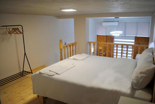 a bedroom with a large white bed in a room at Guest House Dashi in Gjirokastër