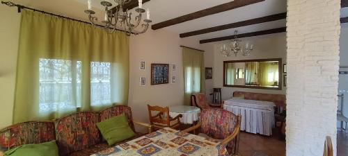 a living room with a couch and a table at Cortijo La Torre de Caniles in Fábrica Azucarera