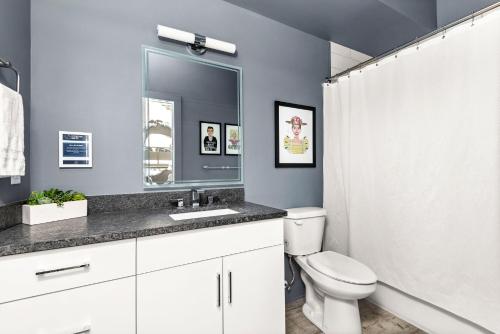 a bathroom with a toilet and a sink and a mirror at Mason Lofts at West End in Nashville