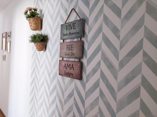 a room with a chevron accent wall with two potted plants at La Peruyal, 30 in Arriondas