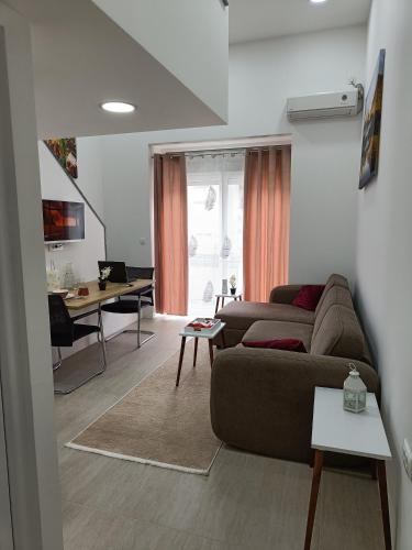 a living room with a couch and a table at Korzo Apartment in Bijelo Polje