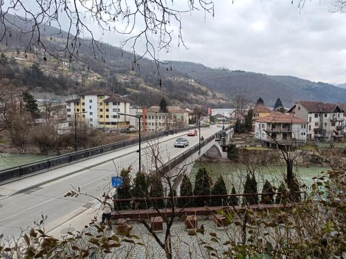 a city with a bridge over a river and buildings at Korzo Apartment in Bijelo Polje