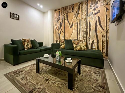 a living room with a green couch and a table at Giza Pyramids View Inn in Cairo