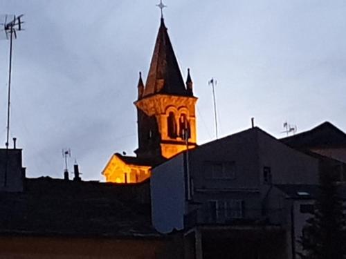 a church steeple in the background of a city at Sleeping Sarria in Sarria