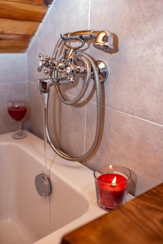 a candle sitting on a sink with a faucet at Rustic Home Tara in Kaludjerske Bare