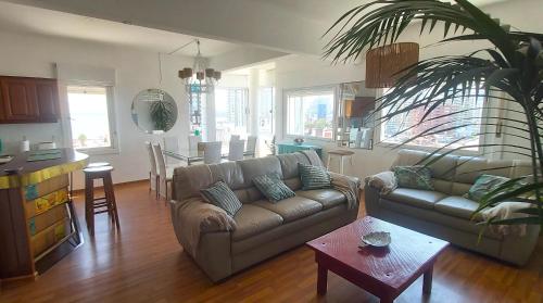 un soggiorno con un divano e un tavolo di Imperdible vista y ubicacion en Punta del Este a Punta del Este