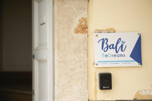 a sign on a wall that says ball be dreams at Bali AQUA&CHARME in Gaeta