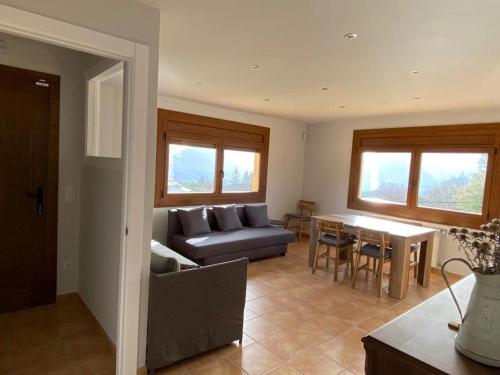 a living room with a couch and a table at Allotjament Cal Bru in Sant Llorenç de Morunys