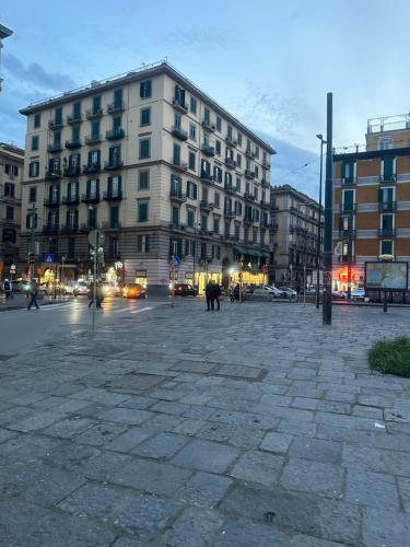 a city street with a large building and cars at Alexander hostel in Naples