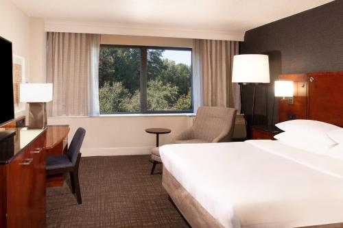 a hotel room with a large bed and a window at Marriott Raleigh Durham Research Triangle Park in Durham