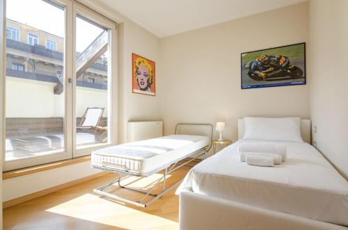 A bed or beds in a room at Rizzoli Terrace Apartment