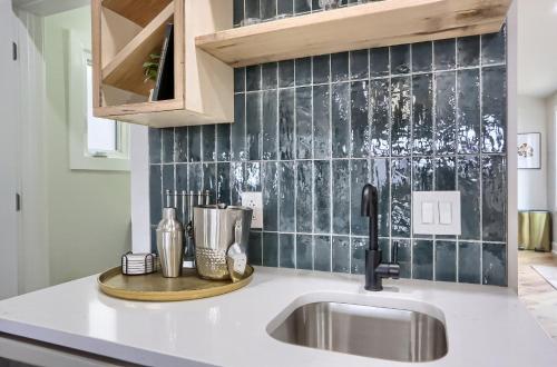 a kitchen with a sink and a counter top at Urban Oasis Retreat With Luxury Design, Hot Tub, Fire Pit, Breathtaking Downtown & River Views in Pittsburgh