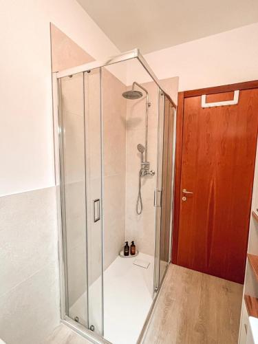 a shower with a glass door in a bathroom at 583slm in Aosta