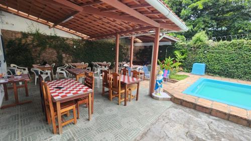a patio with a table and chairs and a swimming pool at BUONA SORTE in Lençóis