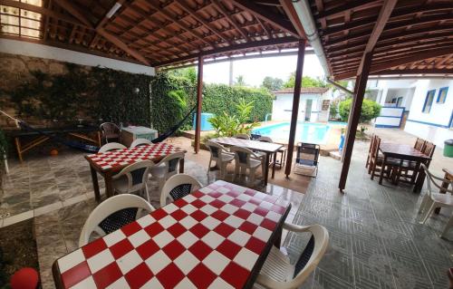 a patio with tables and chairs and a pool at BUONA SORTE in Lençóis