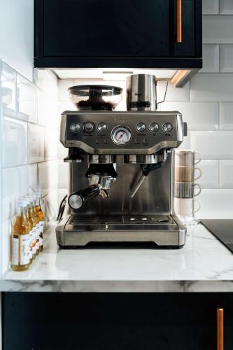 a coffee maker sitting on a counter in a kitchen at Luxury Renovated Bungalow with wheel chair access, Hot Tub and Fire Pit in Wouldham