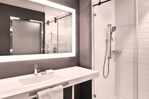a bathroom with a sink and a shower at AC Hotel by Marriott Nashville Brentwood in Brentwood
