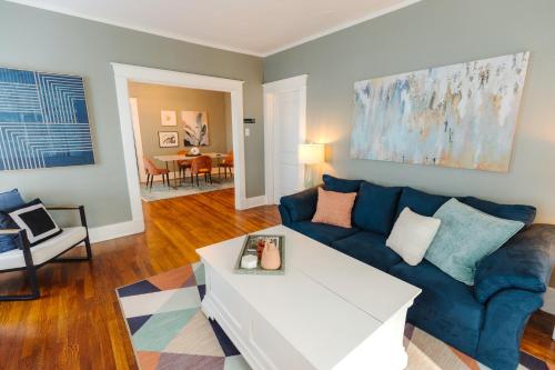 a living room with a blue couch and a table at Historic Revival 2BR Midtown Memphis Free Parking Fast Wifi Free Parking Yes Pets in Memphis