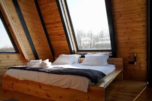 a bed in a room with a large window at Ordu Bungalov-Loin du Monde in Perşembe