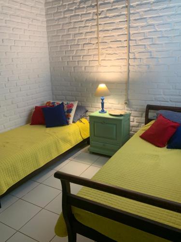 two beds sitting next to each other in a room at Casa da Baía in Angra dos Reis