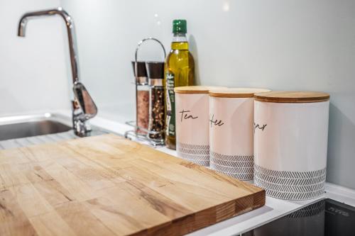 a counter with two wooden cutting boards and a bottle of wine at Spacious & Cosy Studio Flat in the Heart of Edinburgh City Centre in Edinburgh