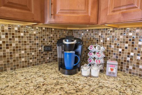 a coffee maker on a counter in a kitchen at Sapphire Oasis- Heavenly Ocean View and Resort in Kahana