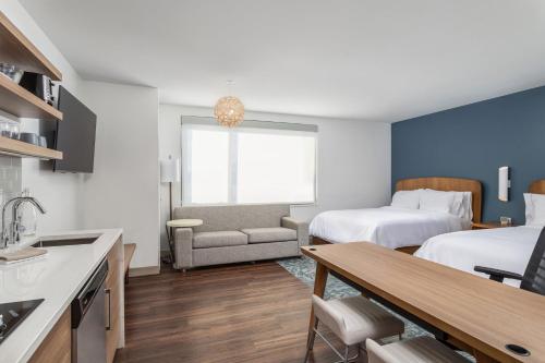 a kitchen and a living room with two beds and a table at Element Knoxville West in Knoxville