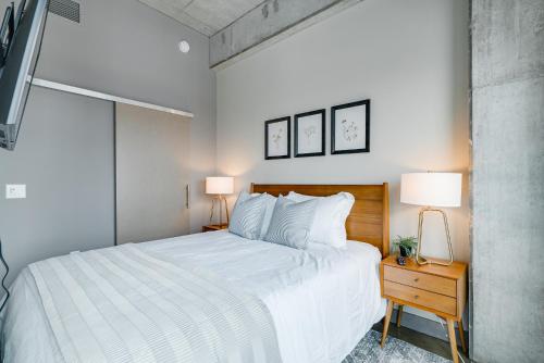 a bedroom with a large white bed and two lamps at Sable 82 in Minneapolis